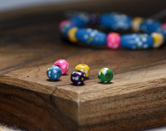 Bead mix, painted wood, mixed colors, 5-6mm irregular round with flower design. Sold per pkg of 100.