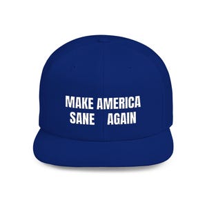 May include: A royal blue baseball cap with a flat brim. The cap features the white text "MAKE AMERICA SANE AGAIN" across the front. The hat is a classic style, suitable for casual wear.
