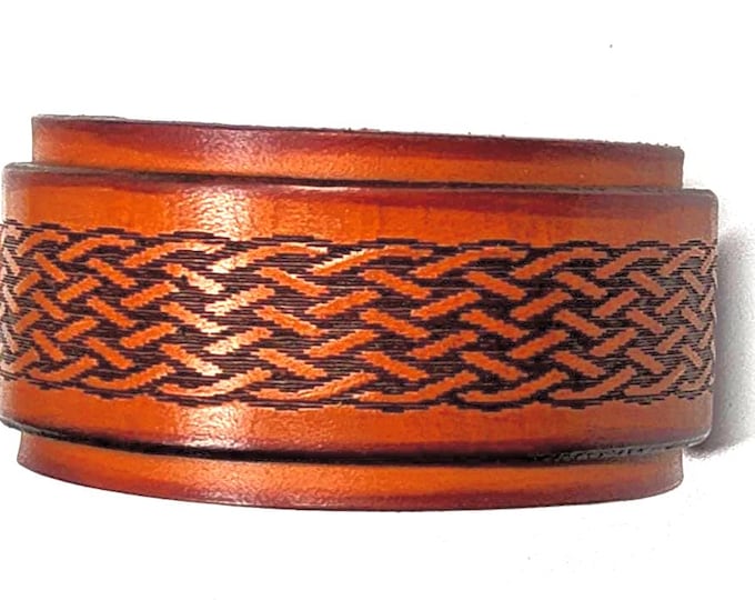 Hand crafted leather wrist cuff with celtic pattern engraving.