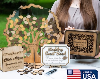 May include: Wooden wedding guest book set with a tree-shaped design, leaf-shaped guest signing pieces, and a decorative box. The set includes a sign that reads "Wedding Guest Book". The set is made in the USA.
