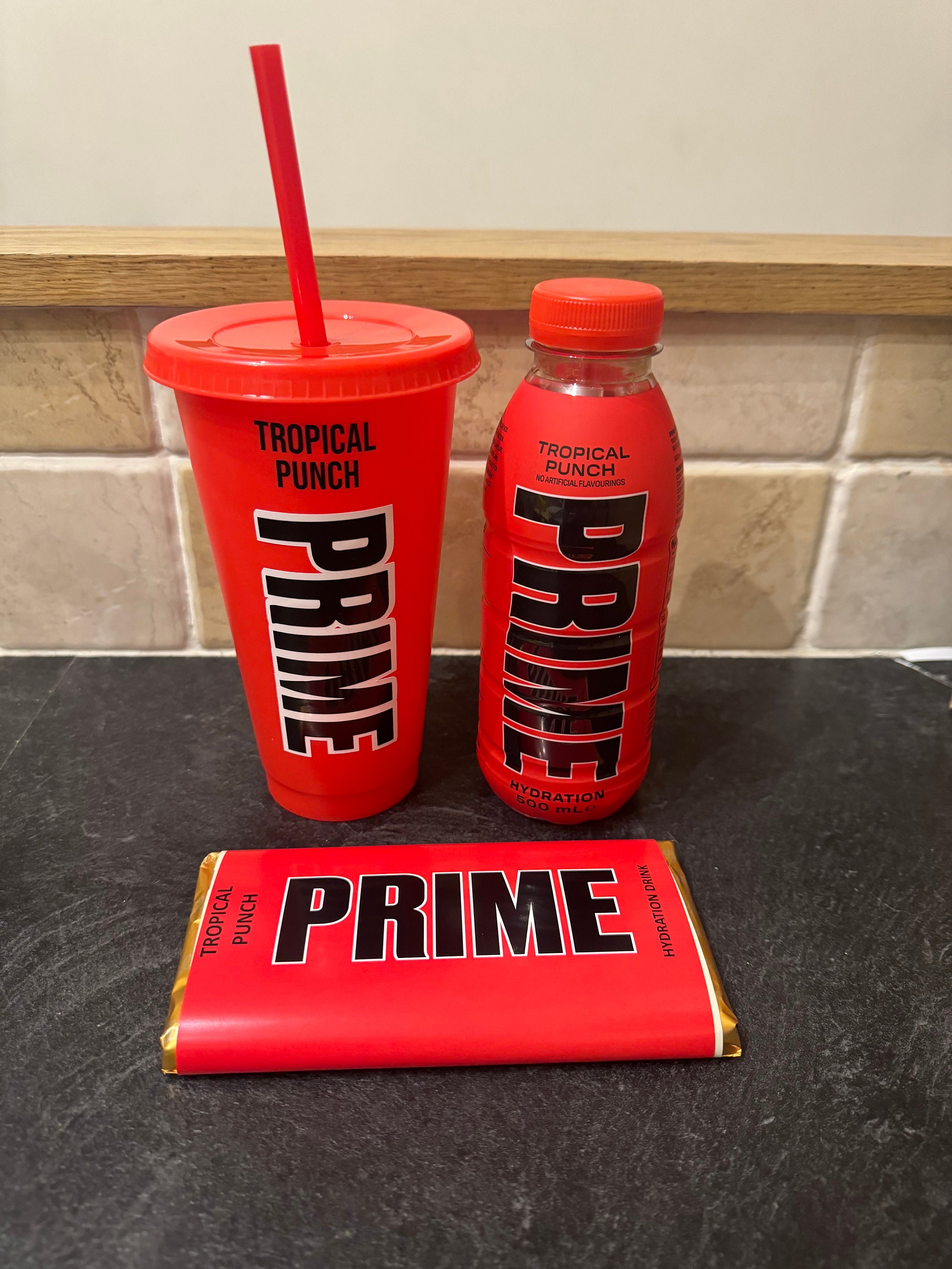 Prime hydration tropical punch full unopened bottle, 24oz cold cup and galaxy chocolate bar pack.