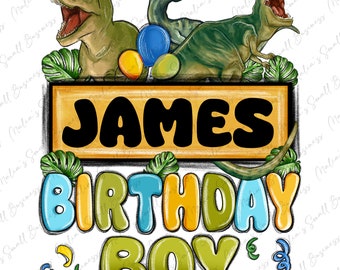 May include: A birthday card featuring a green, yellow, and blue dinosaur theme. The card says "JAMES BIRTHDAY BOY" in a colorful, cartoon font.