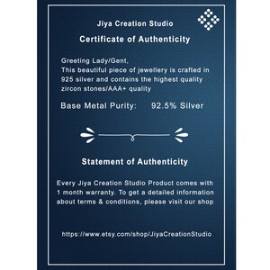 May include: A dark blue certificate from Jiya Creation Studio, with white text. The certificate states the jewelry is crafted in 925 silver with zircon stones. It includes a warranty statement and the Etsy shop URL.