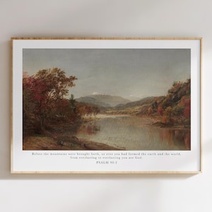 May include: Framed landscape art print featuring a serene lake scene with autumn foliage in shades of red and brown. The artwork includes text from Psalm 90:2, set against a neutral background, encased in a wooden frame.