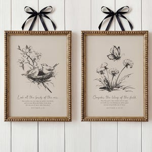 May include: Two framed art prints with gold beaded edges and black bows. One shows a bird in a nest with text, "Look at the birds of the air." The other depicts a butterfly and flowers with the text, "Consider the lilies of the field."