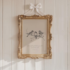May include: A framed print featuring a detailed illustration of three birds perched on a branch. The artwork is in black and white, set against a beige background, and framed in an ornate gold frame. The print is adorned with a white bow and includes the text "Let everything that has breath praise the Lord!" and "Psalm 150:6".