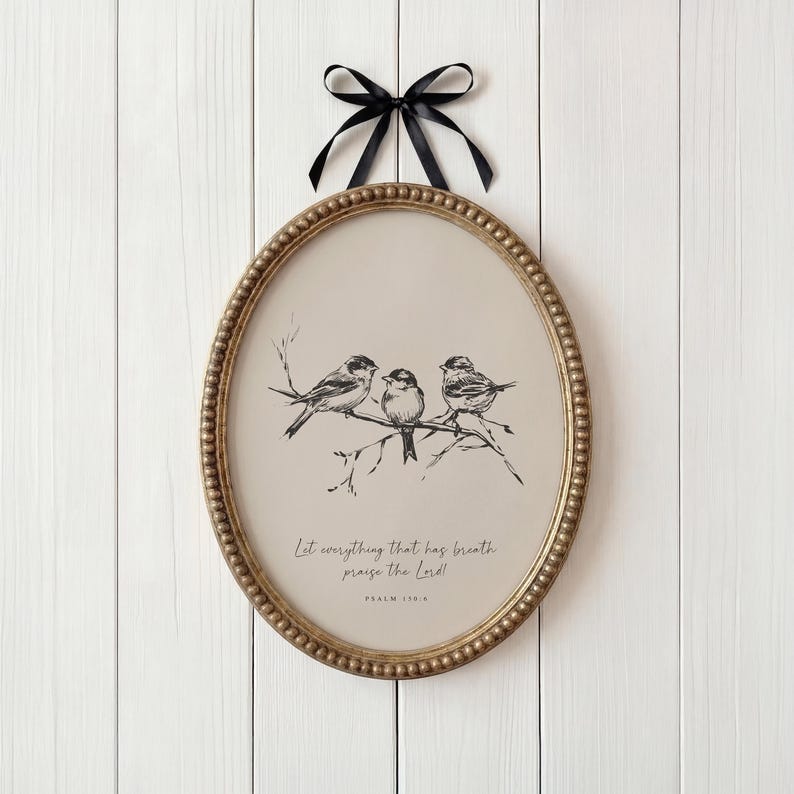May include: An oval-shaped framed print featuring a black and white illustration of three birds perched on a branch. The frame is gold with a beaded edge, and a black ribbon is attached for hanging. The print includes the text "Let everything that has breath praise the Lord!" and "Psalm 150:6."