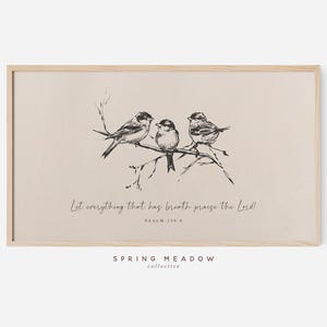 May include: A framed print featuring a black and white illustration of three birds perched on a branch. The artwork includes the text "Let everything that has breath praise the Lord!" and "Psalm 150:6". The frame is a light wood color.