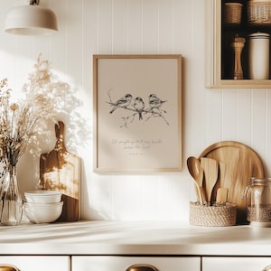 May include: A framed print featuring three birds perched on a branch, rendered in black and white. The print includes the text "Let everything that has breath praise the Lord!" in a script font. The frame is light brown.