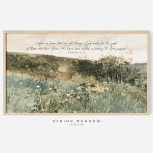 May include: A framed print featuring a pastoral landscape in muted greens and browns. The artwork includes scriptural text from Romans 8:28, with the words "Spring Meadow Collective" at the bottom. The overall aesthetic is vintage and serene.