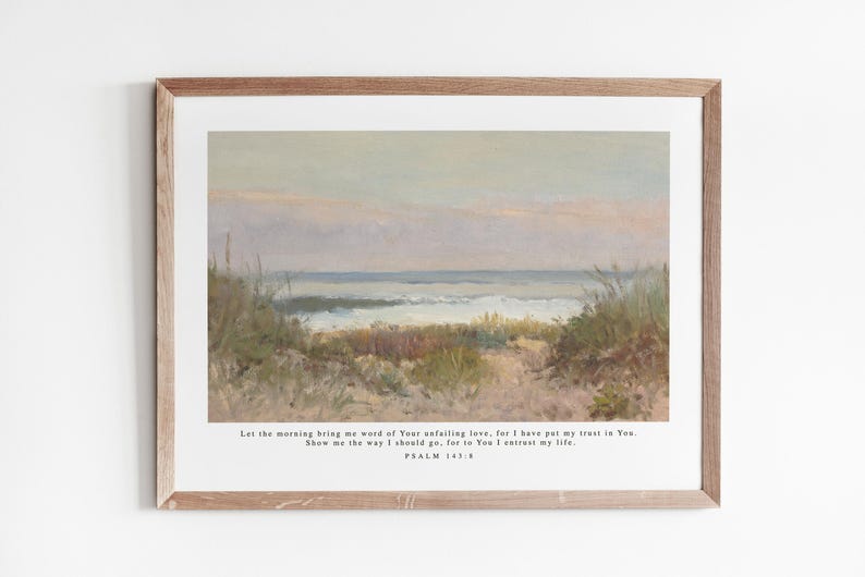May include: A framed print with a painting of a seascape. The painting shows a beach with tall grasses and a view of the ocean. The print includes a quote from Psalm 143:8: "Let the morning bring me word of Your unfailing love, for I have put my trust in You. Show me the way I should go, for to You I entrust my life."