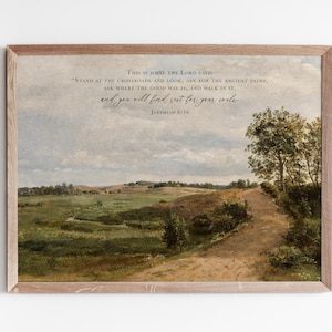 May include: A framed art print depicting a rural landscape with a path and text from Jeremiah 6:16. The print is in a wooden frame, ideal for home decoration. The artwork shows a field under a cloudy sky.