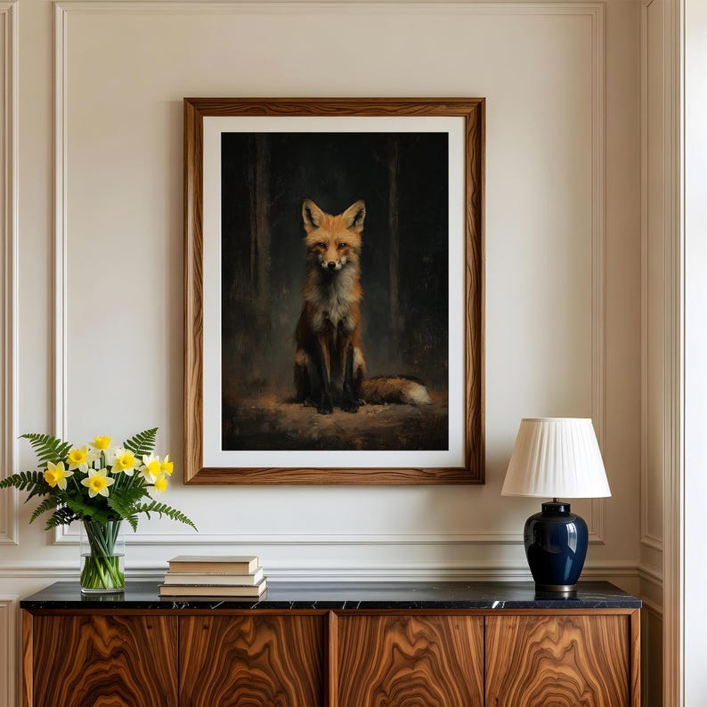 May include: A framed art print featuring a detailed painting of a fox. The fox has reddish-brown fur and is sitting in a forest setting. The artwork is displayed in a wooden frame, adding a touch of rustic charm to the decor.