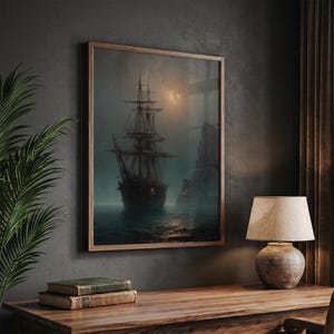 May include: A framed wall art print depicting a dark, multi-masted sailing ship on a misty, moonlit sea near a rocky cliff. The artwork features muted tones of gray, brown, and deep blue, capturing a somber maritime scene with a single glowing light.