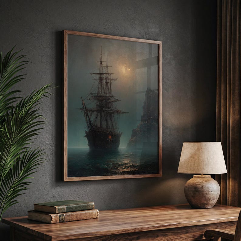May include: A framed wall art print depicting a dark, multi-masted sailing ship on a misty, moonlit sea near a rocky cliff. The artwork features muted tones of gray, brown, and deep blue, capturing a somber maritime scene with a single glowing light.