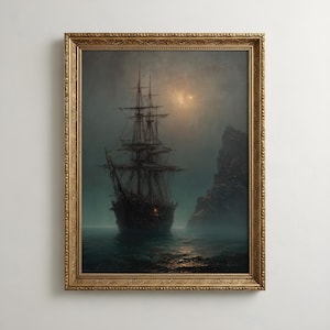 May include: A framed wall art print depicting a dark, multi-masted sailing ship on calm, misty water at night. A rocky cliff stands to the right under a dim, glowing moon. The ship features a single small, glowing red light on its hull.