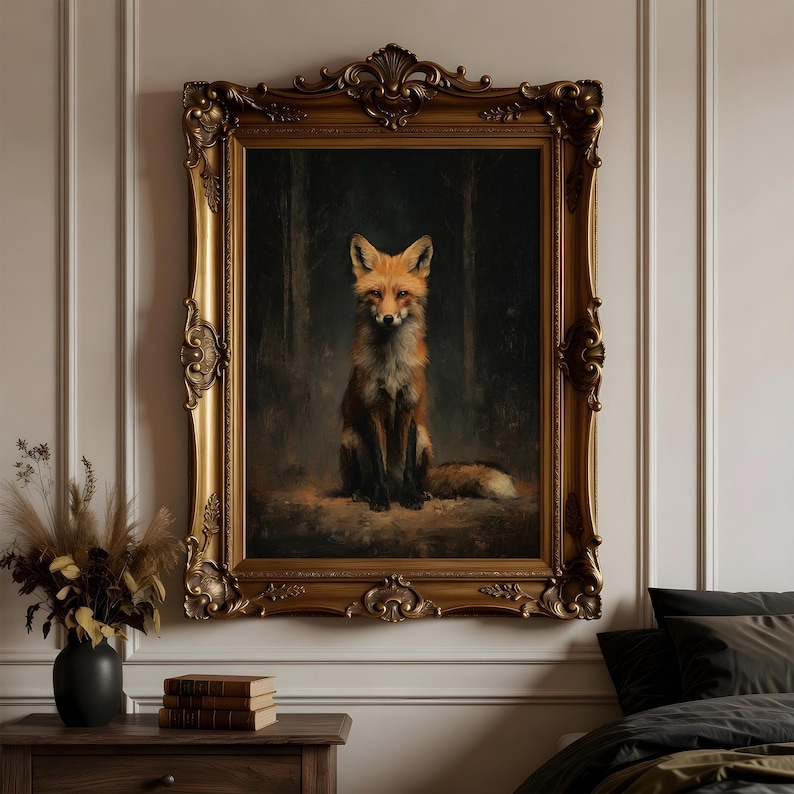 May include: A framed oil painting of a fox. The fox is depicted in a seated position, with a reddish-orange coat and a bushy tail. The painting is set against a dark forest background and is encased in an ornate gold frame.