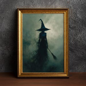May include: A framed wall art print featuring a dark, shadowy silhouette of a figure wearing a pointed hat and holding a broomstick. The figure is set against a moody, swirling gray and green fog background, enclosed in an ornate gold frame.