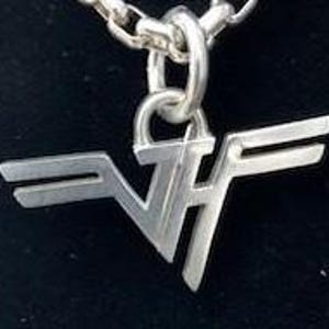May include: Silver pendant necklace featuring a stylized 'VF' logo with wings. The pendant is attached to a silver chain.