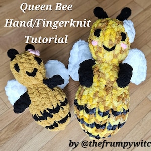May include: Two hand-knitted plush bee toys, one larger than the other. Both are yellow and black with white wings and black eyes. The larger bee has a pink blush on its cheeks. The smaller bee has a pink flower on its head. The text "Queen Bee Hand/Fingerknit Tutorial by @thefrumpywitch" is visible at the bottom of the image.