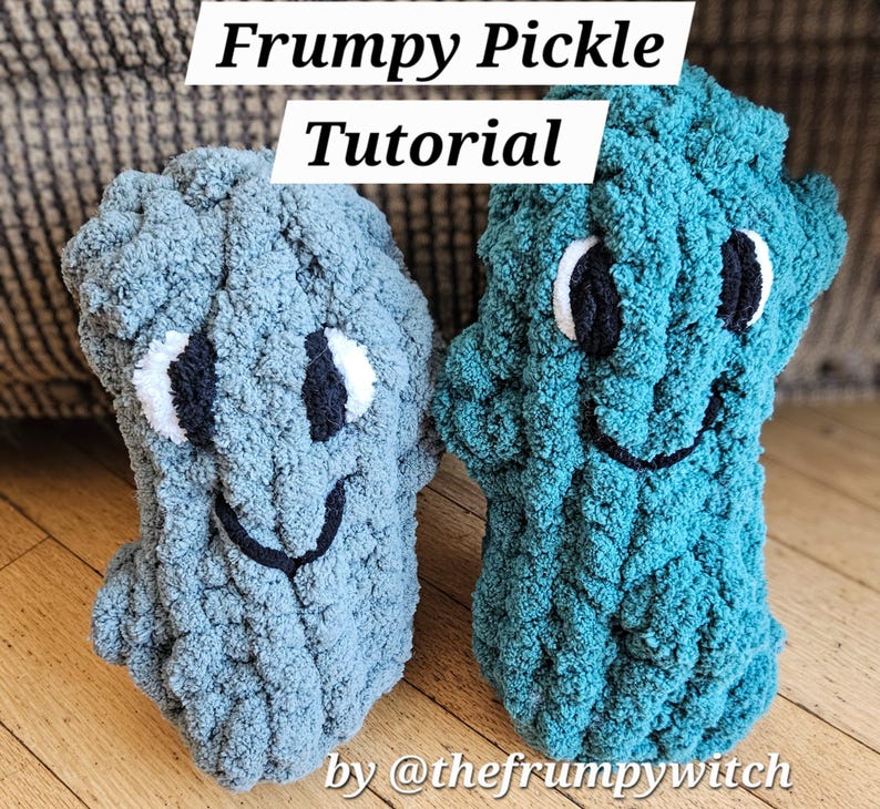 May include: Two plush, handmade pickle-shaped toys in shades of blue and teal. Each has a smiling face with black and white details. The text "Frumpy Pickle Tutorial" is at the top, and "by @thefrumpywitch" is at the bottom.