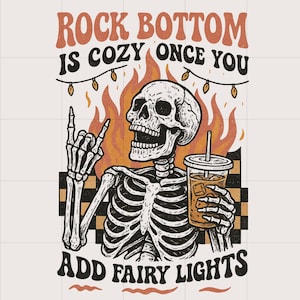 May include: Illustration of a skeleton with a drink, flames, and fairy lights. Text reads "Rock Bottom is Cozy Once You Add Fairy Lights." The skeleton is giving a rock and roll hand gesture.