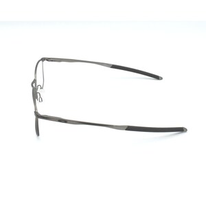 May include: A pair of silver-toned metal spectacles with black temple tips.