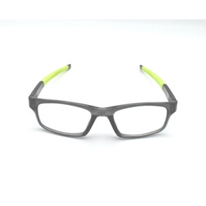 May include: Gray rectangular eyeglasses with lime green arms.