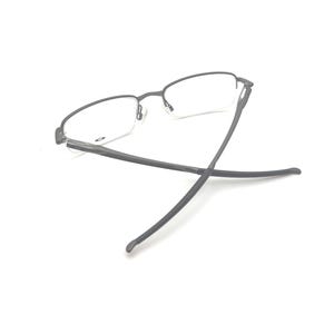 May include: A pair of eyeglasses with a dark gray metal frame and clear lenses. The glasses are set against a white background, with the temples extended. The design is minimalist and modern.