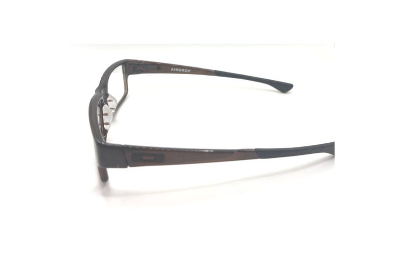 May include: A pair of eyeglasses with a dark brown frame and black temples. The text "AIRDROP" is visible on the frame. The glasses are set against a white background.