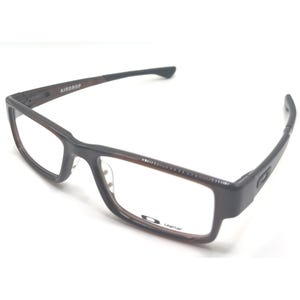May include: Brown and black rectangular eyeglasses with the word "AIRDROP" on the left arm. The glasses have a dark brown frame and clear lenses. The brand name "Oakley" is visible on the right lens.