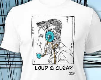 May include: White t-shirt with a black and white illustration of a person wearing a headset with a blue microphone. The text "LOUD & CLEAR" is printed below the illustration.