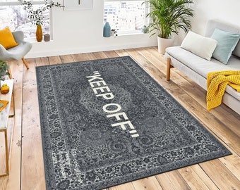May include: A gray and white area rug with a vintage floral pattern and the text "KEEP OFF!" in white.