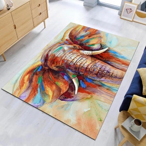 May include: A watercolor painting of an elephant's face with splashes of orange, red, blue, and green paint.