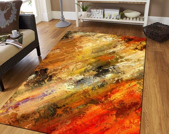 May include: Abstract area rug with a colorful design featuring shades of orange, yellow, brown, and black. The rug has a distressed, textured look.