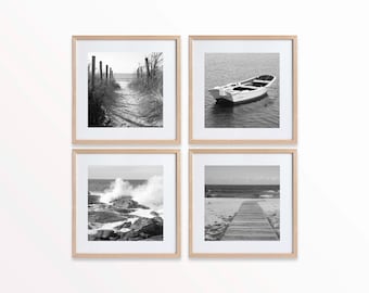 Puede incluir: Un conjunto de cuatro fotografías en blanco y negro en marcos de madera, cada una representando una escena de playa diferente. La primera foto muestra un camino que lleva a la playa, la segunda muestra un pequeño bote en el agua, la tercera muestra olas rompiendo y la cuarta muestra una pasarela de madera que lleva a la playa.