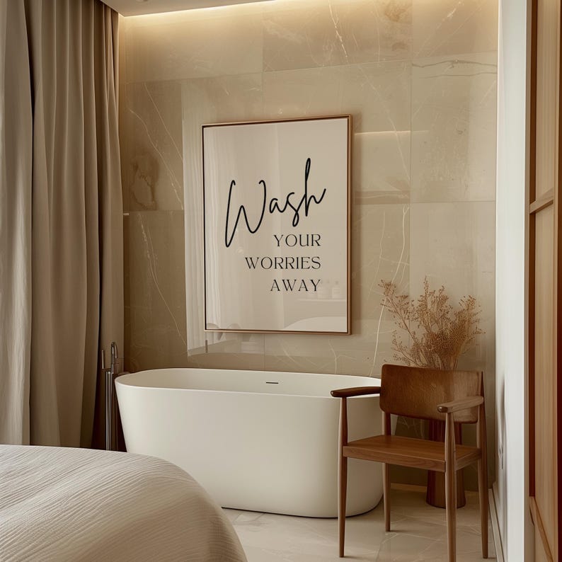 May include: A white bathtub with a framed print above it that reads "Wash your worries away". A wooden chair is to the right of the tub.