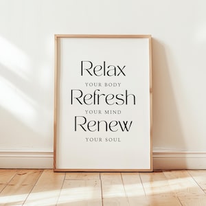 Puede incluir: Una impresión enmarcada con el texto "Relax your body, Refresh your mind, Renew your soul" en texto negro sobre fondo blanco.