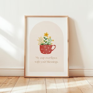 May include: A printable art print with a red and white polka dot cup overflowing with yellow flowers. The text "My cup overflows with your blessings." is printed below the cup.