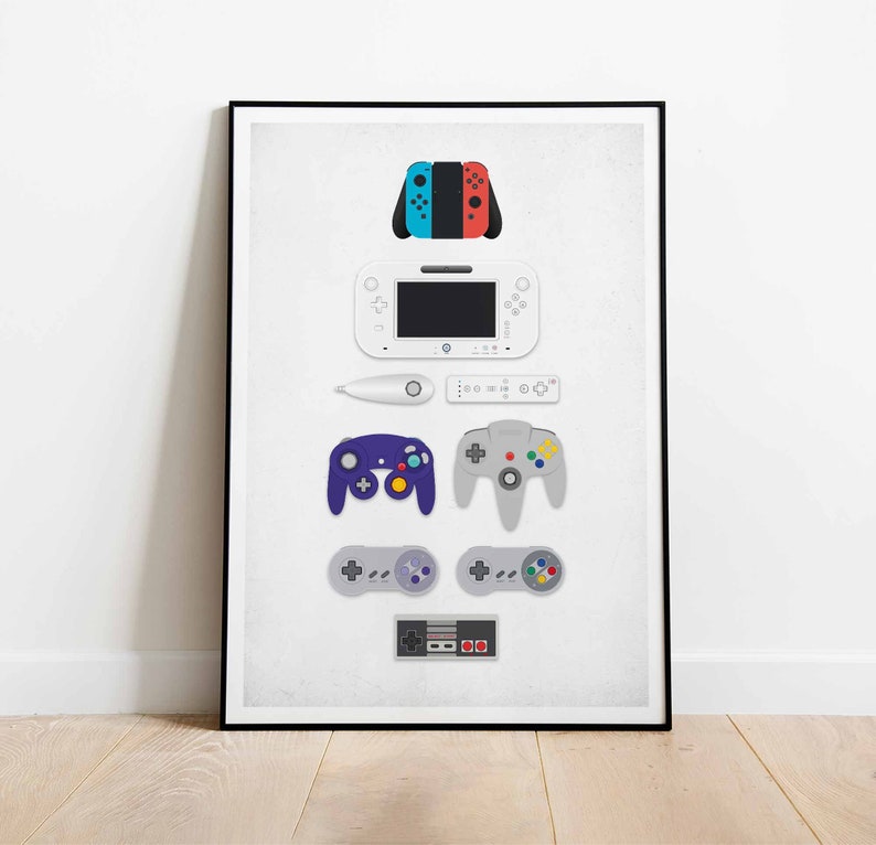 May include: A white poster with a black frame featuring a collection of video game consoles and controllers. The consoles include a Nintendo Switch, a Wii U, a GameCube, a Nintendo 64, and a NES. The controllers include a Switch Joy-Con, a Wii Remote, a GameCube controller, a Nintendo 64 controller, and a NES controller.