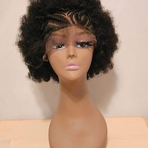 May include: A black afro wig with a lace front and braided details. The wig is styled in a short, curly afro.
