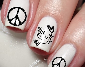 May include: White nail polish with black peace symbols and a dove carrying an olive branch design. The nails are professionally painted with a glossy finish. The image includes the text "Nailodia" and "Proudly Designed and Produced in Australia."