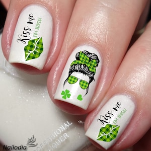 May include: Green and white plaid nail decals with the text "Kiss me I'm Irish" and a cartoon image of a woman with a green and white plaid headband and sunglasses.