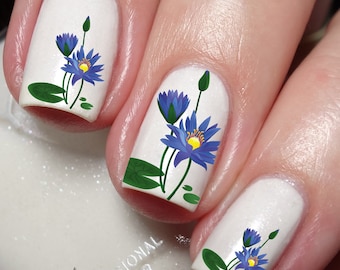 May include: White nail polish with blue and yellow water lily flower nail art decals.