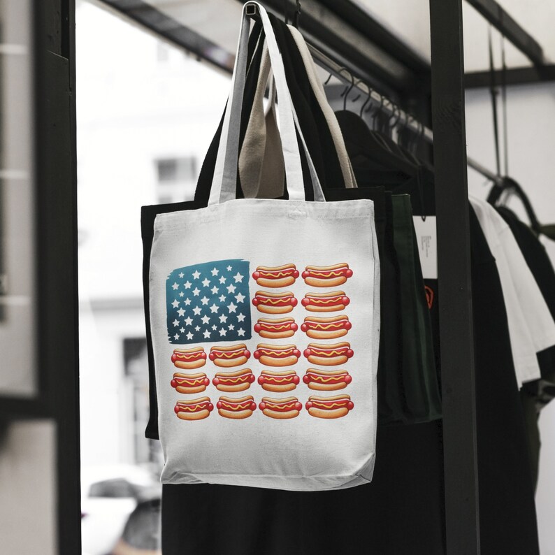 May include: A white tote bag featuring a red, white and blue American flag design. The flag is made up of hot dogs instead of stars and stripes.