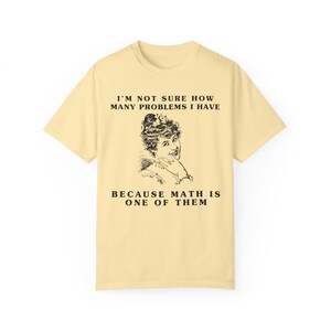 model is wearing Comfort Colors oversized tee shirt in banana (light yellow) with girl math graphic on front