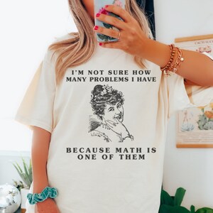 model is wearing Comfort Colors oversized tee shirt in Ivorty (natural) with girl math graphic on front