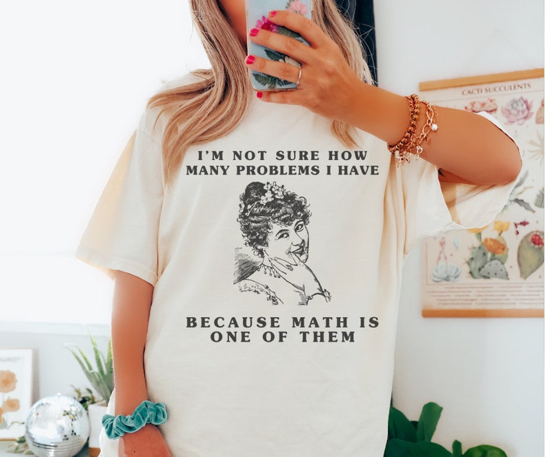 model is wearing Comfort Colors oversized tee shirt in Ivorty (natural) with girl math graphic on front