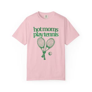 model is wearing comfort colors short sleeve shirt in banana with hot moms play tennis graphic in green on front