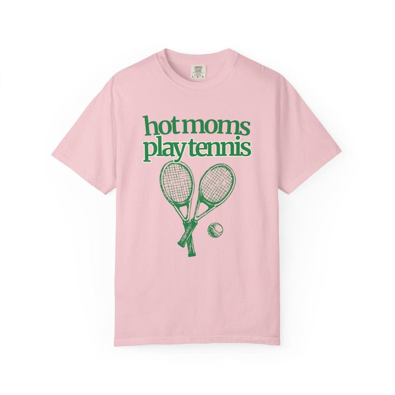 model is wearing comfort colors short sleeve shirt in banana with hot moms play tennis graphic in green on front